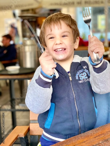 little child playing with a spoon