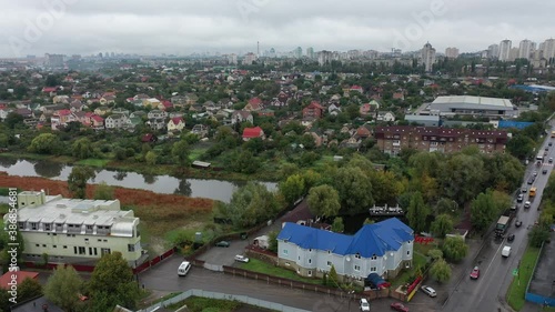 Sofievskaya Borschagovka, Kiev region, Ukraine - October 2020: aerial view of private cottages and apartment buildings in the suburbs. Car traffic in a traffic jam