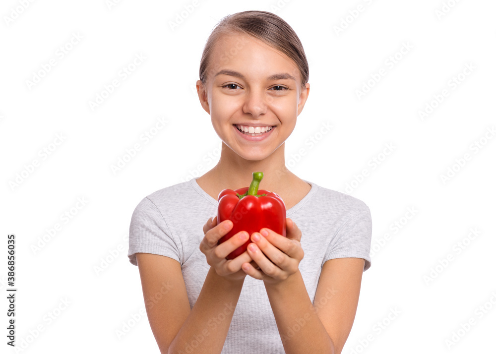 Beautiful young teen girl holding bell pepper, isolated on white background Beautiful young teen girl holding bell pepper, isolated on white background