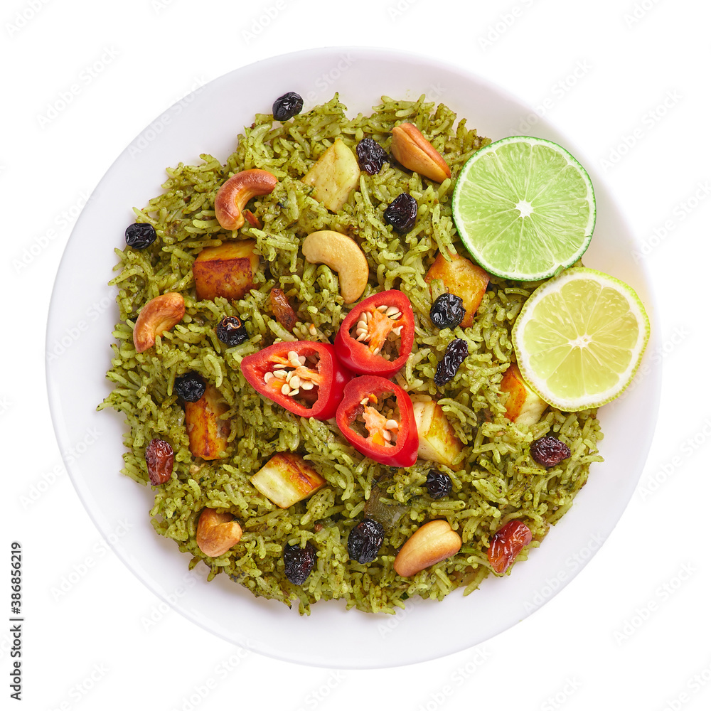 Palak Paneer Biryani isolated on white background. Palak Paneer Biryani is vegetarian indian cuisine dish with spinach, paneer cheese, basmati rice, spices, nuts and raisins. Top view