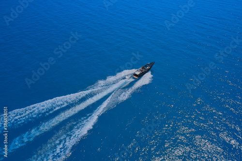 Wallpaper Mural Speed boat movement at high speed aerial view. High-speed yacht of blue color fast motion on blue water in the rays of the sun top view. Torontodigital.ca