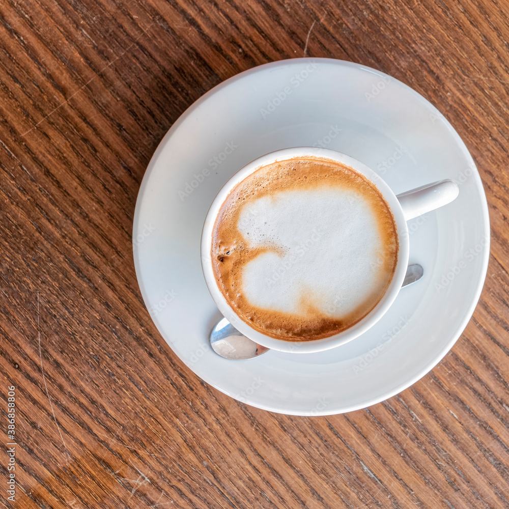 cappuccino coffee cup top vew closeup on wooden table cappuccino coffee cup top vew closeup on wooden table