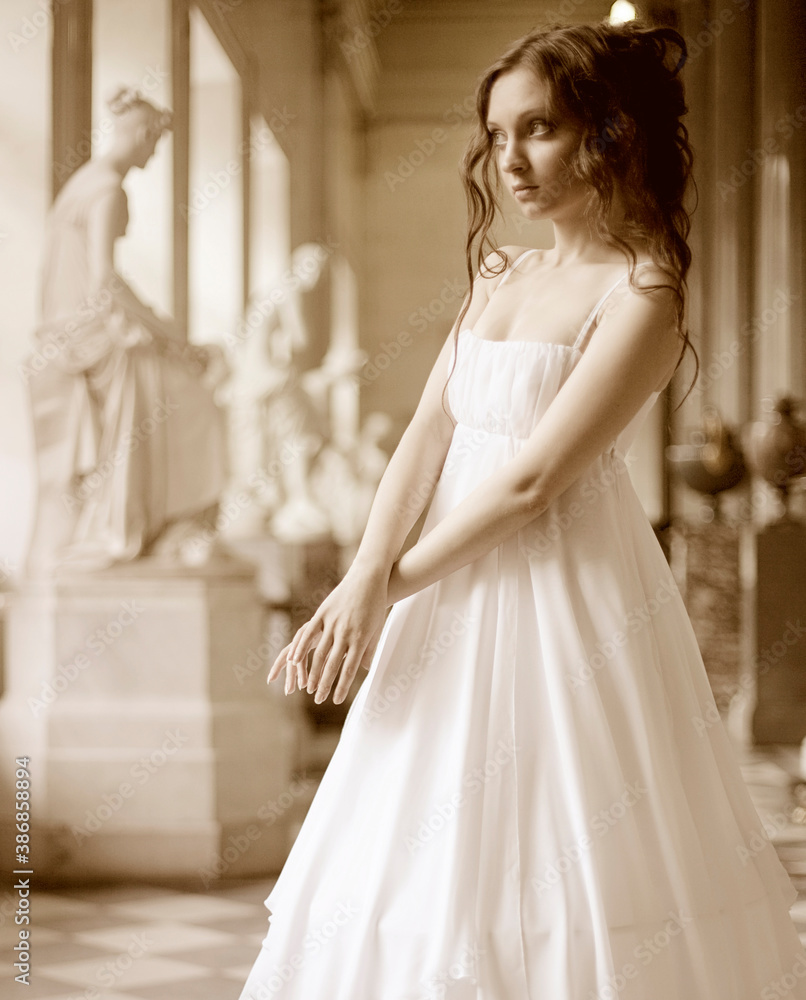 Obraz premium Portrait of a beautiful young victorian lady in white dress