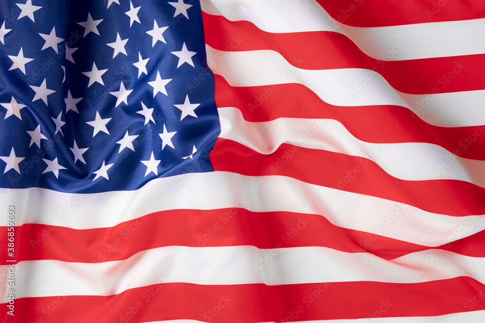 Obraz premium Close up of ruffled American flag. Satin texture curved flag of USA. Memorial Day or 4th of July. Banner, freedom concept