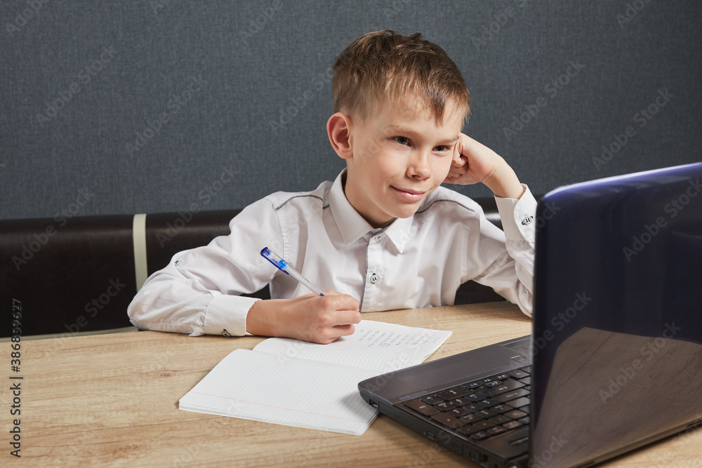 Social Distance learning and online education concept. Kid using laptop for homework. Child stay at home during covid-19 Social Distance learning and online education concept. Kid using laptop for homework. Child stay at home during covid-19