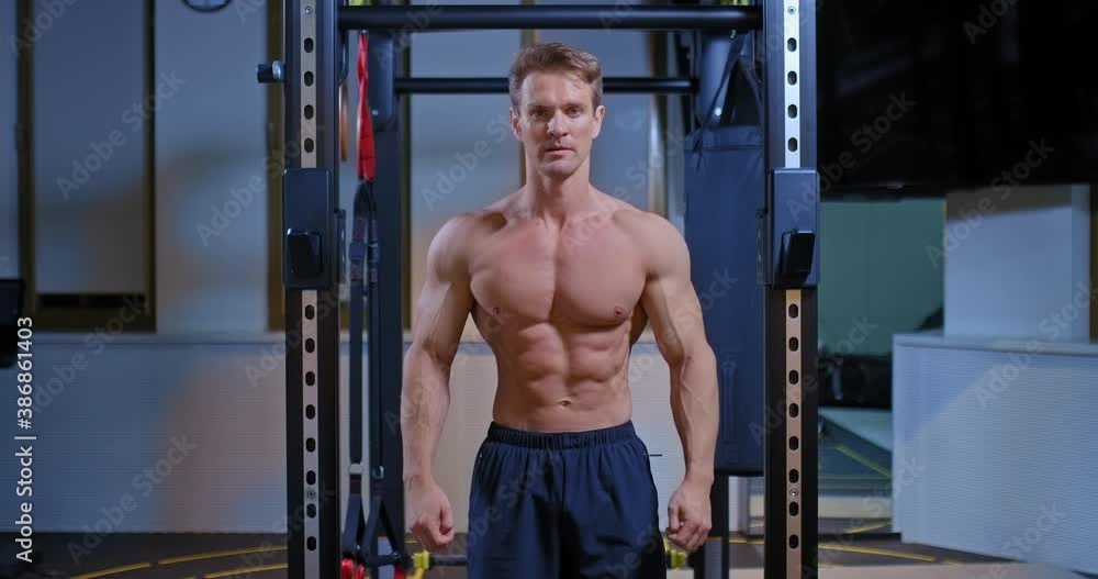 Athlete with pumped up muscles pulls up on a horizontal bar in a modern gym, muscles of the torso and back. Inflated muscles of the body and arms. View from the back. 4k, ProRes Athlete with pumped up muscles pulls up on a horizontal bar in a modern gym, muscles of the torso and back. Inflated muscles of the body and arms. View from the back. 4k, ProRes