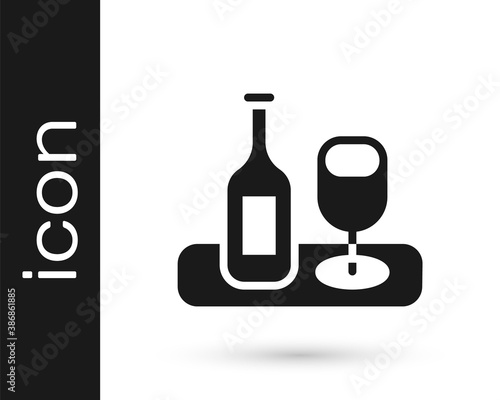 Black Wine bottle with glass icon isolated on white background. Vector.