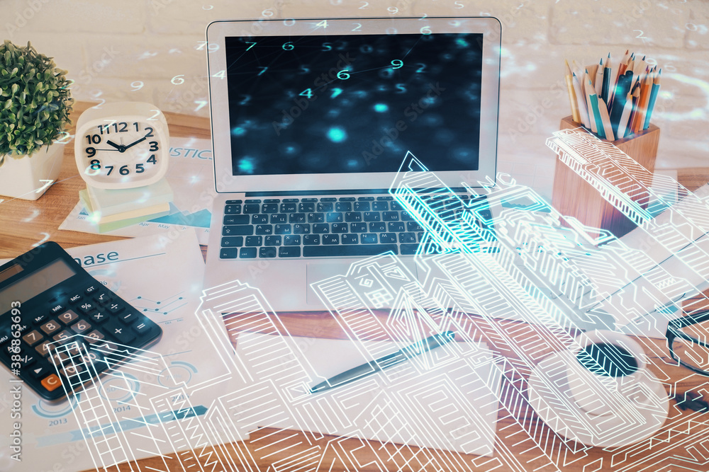 Desktop computer background in office and big town buildings hologram drawing. Double exposure. Smart city concept.
