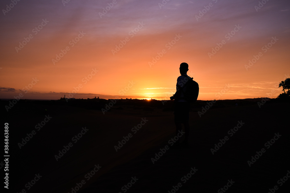 Silhouette of a man watching the sunset.