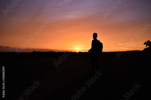 Silhouette of a man watching the sunset.