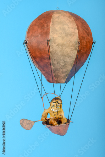 Toy hot air balloon isolated in blue background