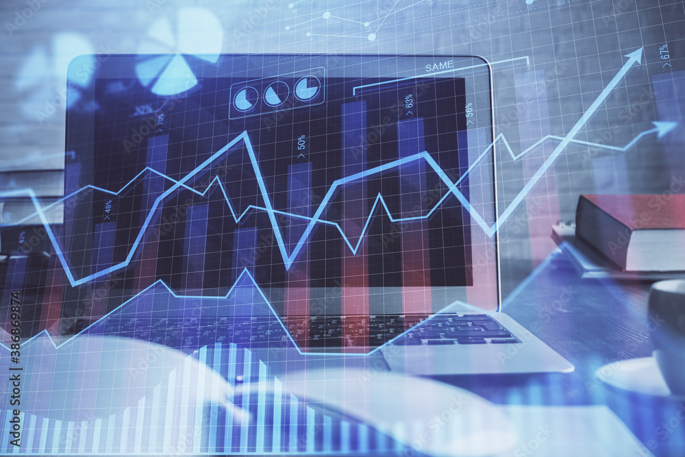 Forex market graph hologram and personal computer on background. Multi exposure. Concept of investment. Forex market graph hologram and personal computer on background. Multi exposure. Concept of investment.