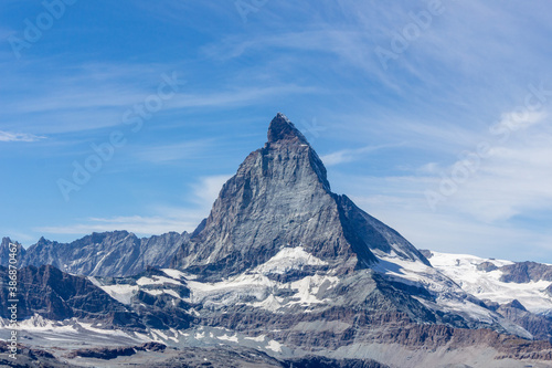 Matterhorn Mountain with white snow and blue sky in summer in Switzerland © sgolovunin