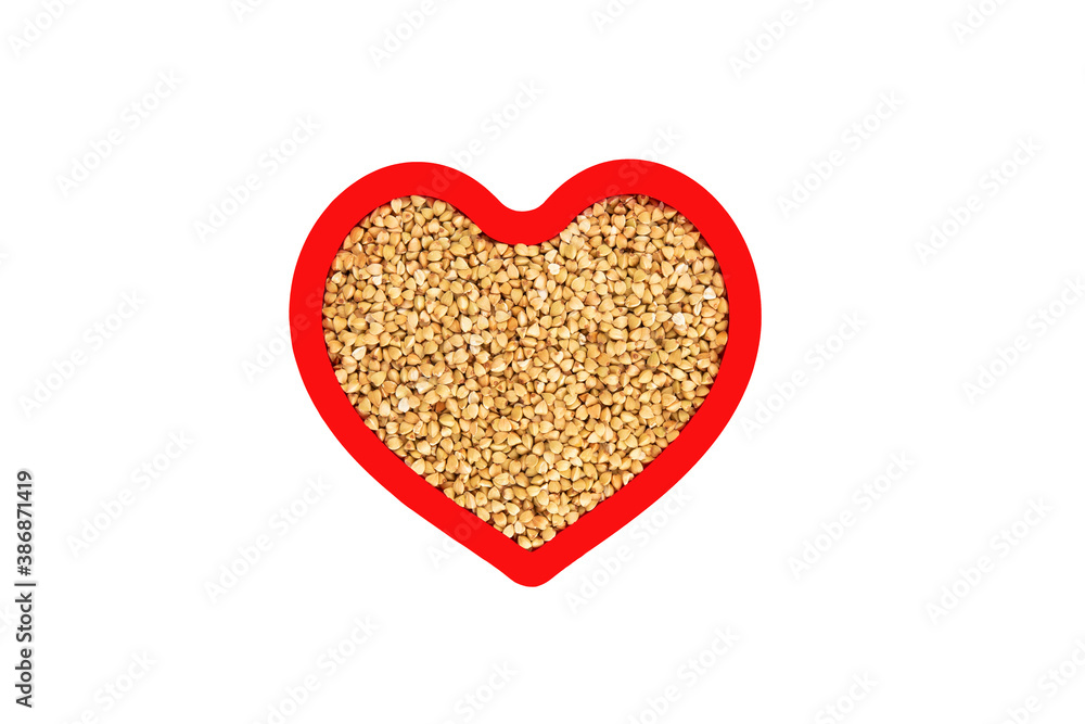Green buckwheat groats in heart shape red frame isolated on white. Green buckwheat groats in heart shape red frame isolated on white.