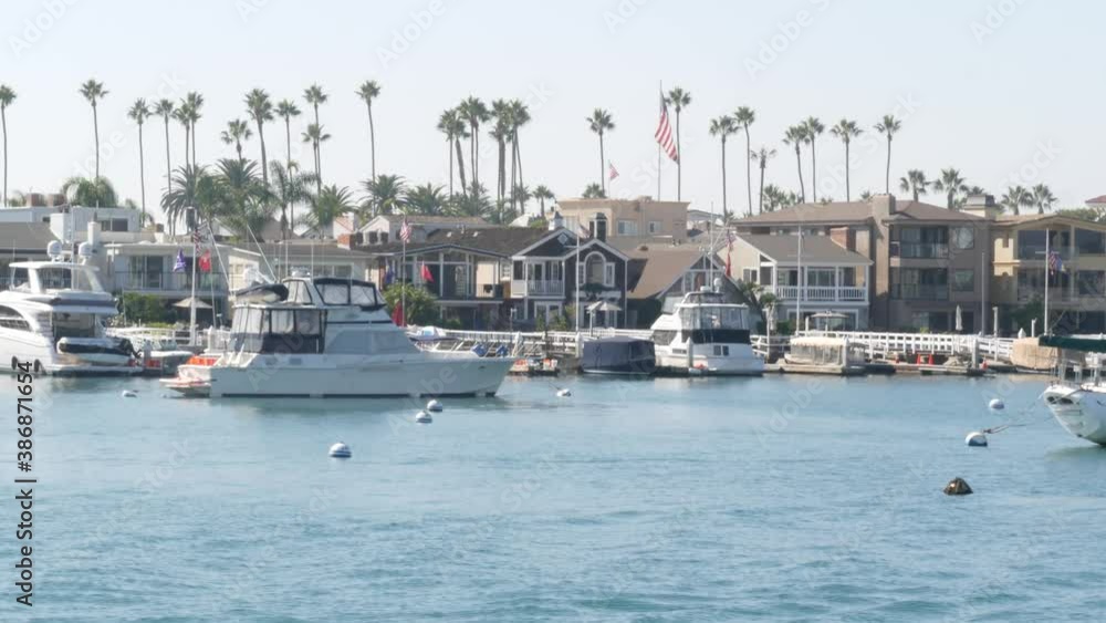 Newport beach harbor, weekend marina resort with yachts and sailboats, Pacific Coast, California, USA. Waterfront luxury suburb real estate in Orange County. Expensive beachfront holiday destination. Newport beach harbor, weekend marina resort with yachts and sailboats, Pacific Coast, California, USA. Waterfront luxury suburb real estate in Orange County. Expensive beachfront holiday destination.