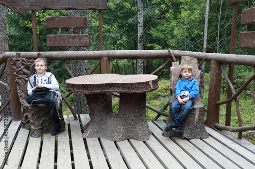 Children sitting on stump chairs photo