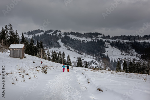 Winter mountain landscape. Tourists walking along the path in the highlands. © Ann Stryzhekin