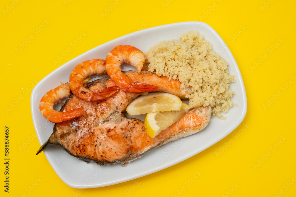 fried salmon with shrimps and cous-cous on white dish fried salmon with shrimps and cous-cous on white dish