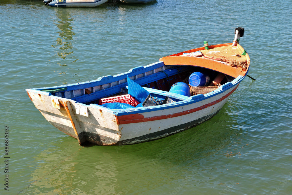 Colourful Small Wooden Fishing Boat Anchored in Sunny Harbour Waters