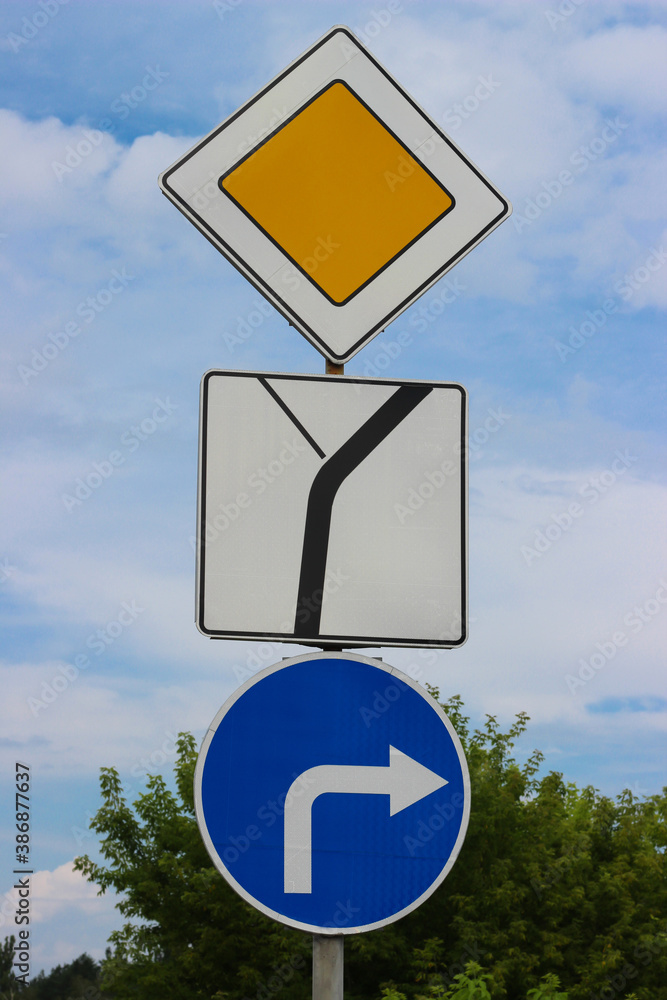 International traffic signs 'Road goes right', 'Priority road', 'The way of priority road' Stock