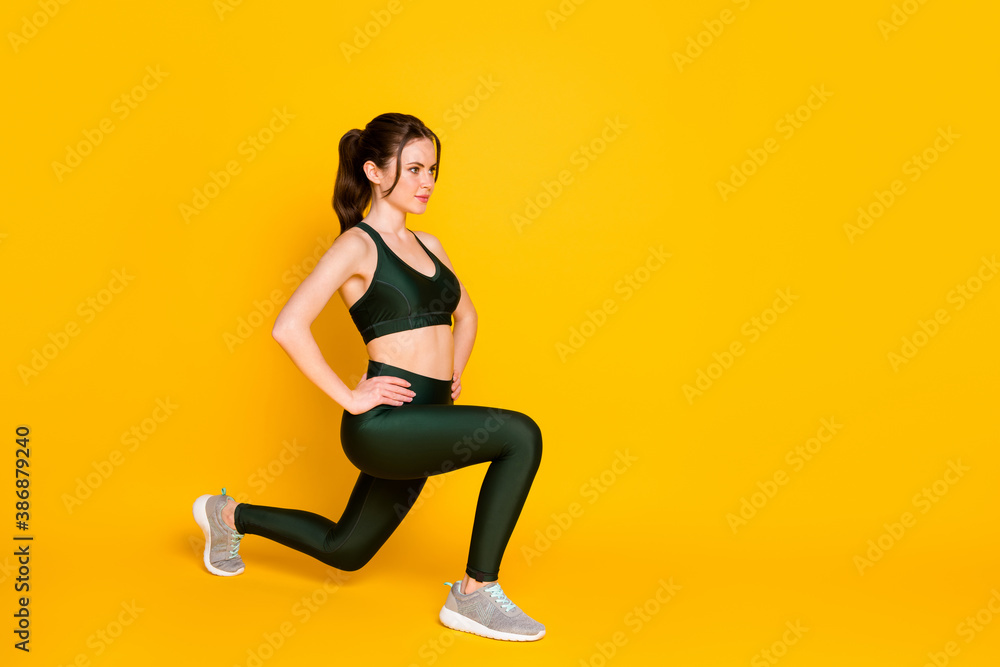 Full length body size view of nice sportive girl trainer doing sit-ups healthy life isolated over bright yellow color background Full length body size view of nice sportive girl trainer doing sit-ups healthy life isolated over bright yellow color background