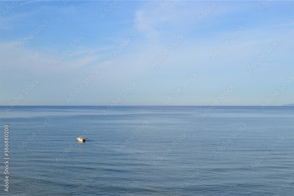 Horizon line: Marmara Sea and blue sky. Coast, blue sea, beach, rocky, raft in the same photo during sunny day of Mudanya, Bursa, Turkey.