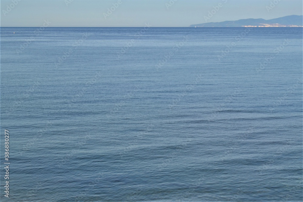 Horizon line: Marmara Sea and blue sky. Coast, blue sea, beach, rocky, raft in the same photo during sunny day of Mudanya, Bursa, Turkey.