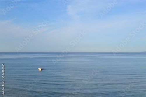 Horizon line: Marmara Sea and blue sky. Coast, blue sea, beach, rocky, raft in the same photo during sunny day of Mudanya, Bursa, Turkey.