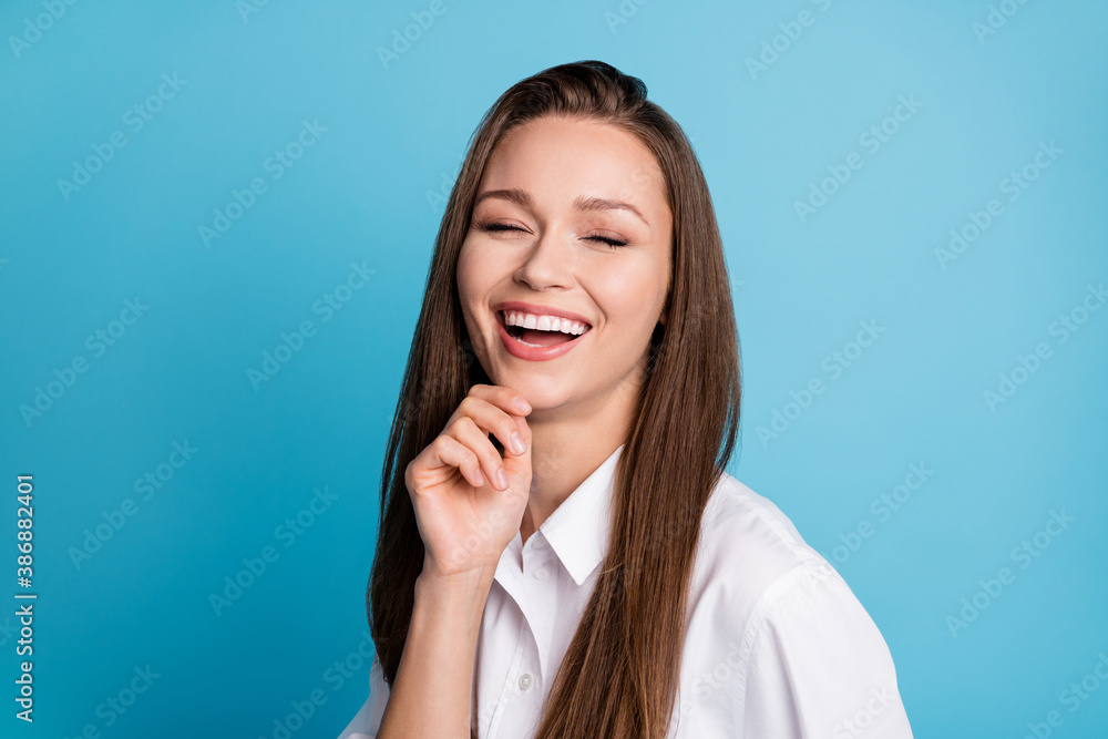Photo of pretty lady good mood friendly laughing out loud wear white shirt isolated blue color background Photo of pretty lady good mood friendly laughing out loud wear white shirt isolated blue color background