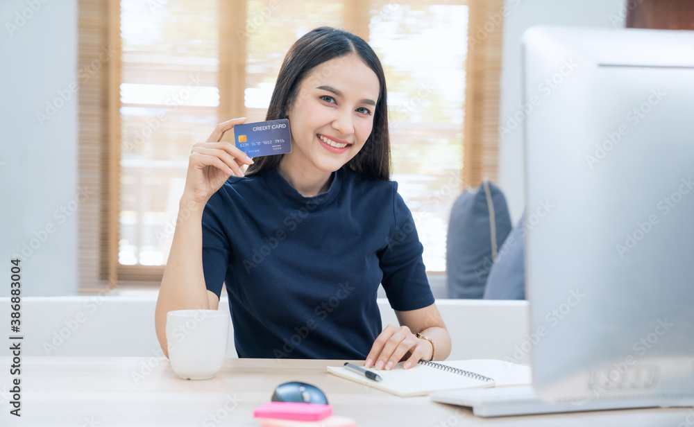Young woman holding credit card and using laptop computer. Businesswoman working at home. Online shopping, E-commerce, internet banking, Spending money, Working from home concept
Young woman holding credit card and using laptop computer. Businesswoman working at home. Online shopping, E-commerce, internet banking, Spending money, Working from home concept