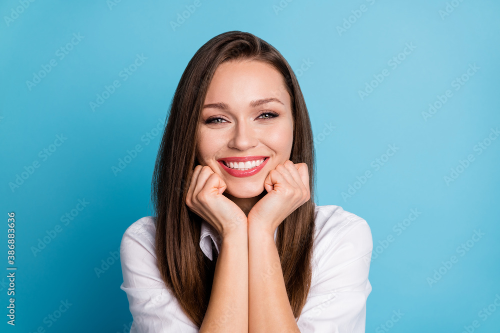 Closeup photo of attractive lady charming beauty appearance arms on cheeks wear white shirt isolated blue color background Closeup photo of attractive lady charming beauty appearance arms on cheeks wear white shirt isolated blue color background