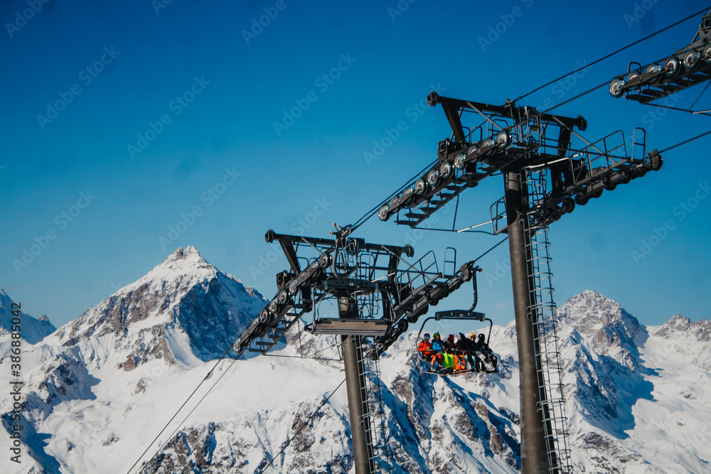 Dombay cable car in winter. Chair lift to the mountains. Ski resort.