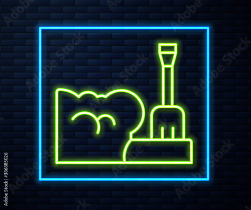 Glowing neon line Shovel in snowdrift icon isolated on brick wall background. Vector.