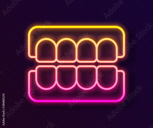 Glowing neon line False jaw icon isolated on black background. Dental jaw or dentures, false teeth with incisors. Vector.