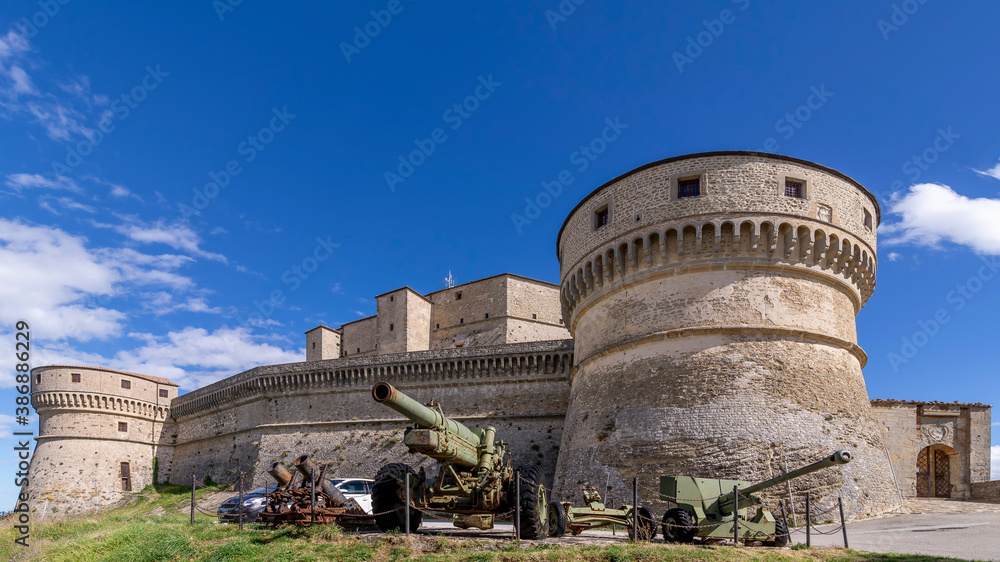 View of the ancient Rocca di San Leo fortress on a sunny day and blue sky, Rimini, Italy