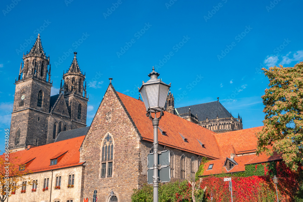 Magnificent Cathedral in historical and shopping downtown of Magdeburg, old town, Elbe river at early golden Autumn, Magdeburg, Germany.