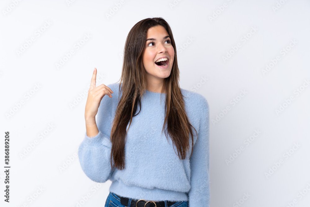 Teenager girl over isolated white background pointing up and surprised Teenager girl over isolated white background pointing up and surprised