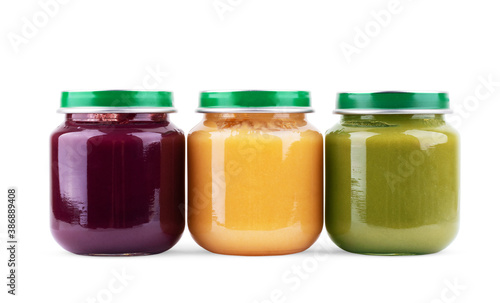 Jars with different baby food on white background