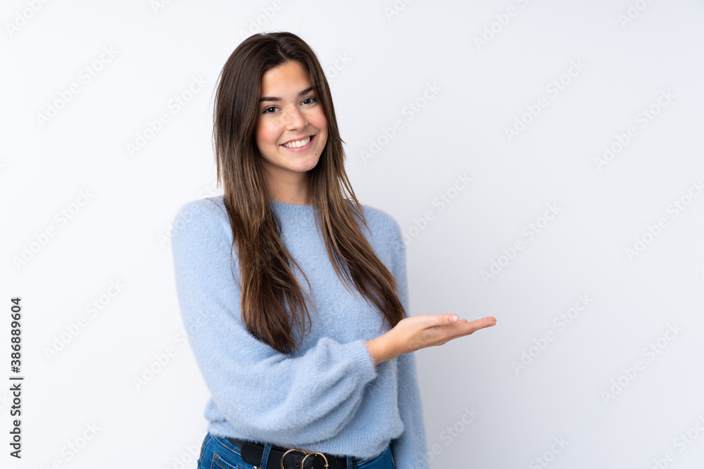 Teenager girl over isolated white background presenting an idea while looking smiling towards Teenager girl over isolated white background presenting an idea while looking smiling towards