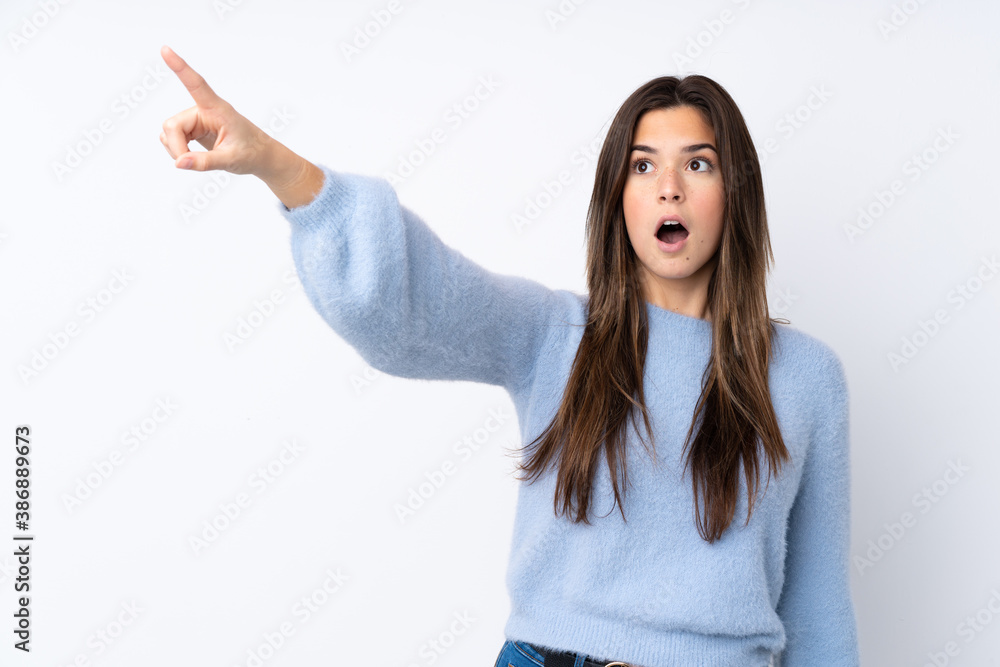 Teenager girl over isolated white background pointing away Teenager girl over isolated white background pointing away