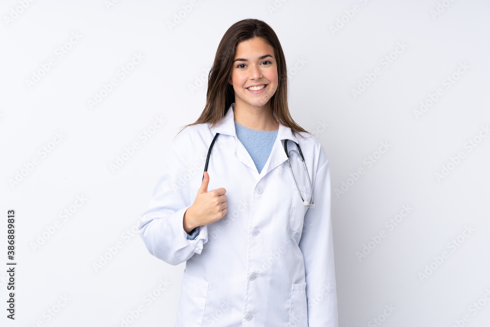 Teenager girl over isolated white background wearing a doctor gown and with thumb up Teenager girl over isolated white background wearing a doctor gown and with thumb up