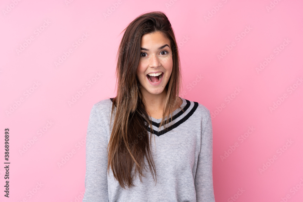 Teenager girl over isolated pink background with surprise facial expression
