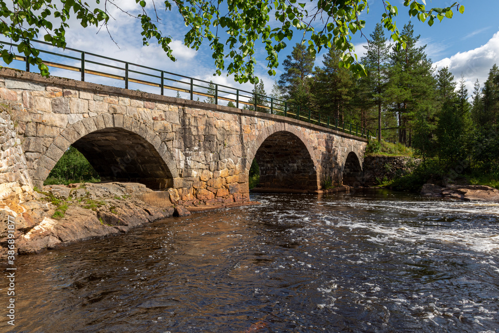 Stone bridge over a little river in northern Sweden Stone bridge over a little river in northern Sweden