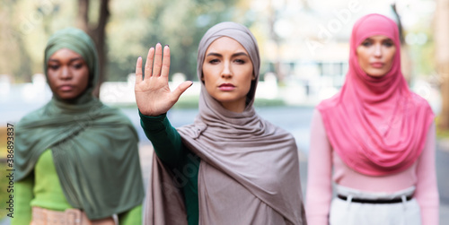 Three Muslim Women Gesturing Stop Protesting Against Something Standing Outdoors