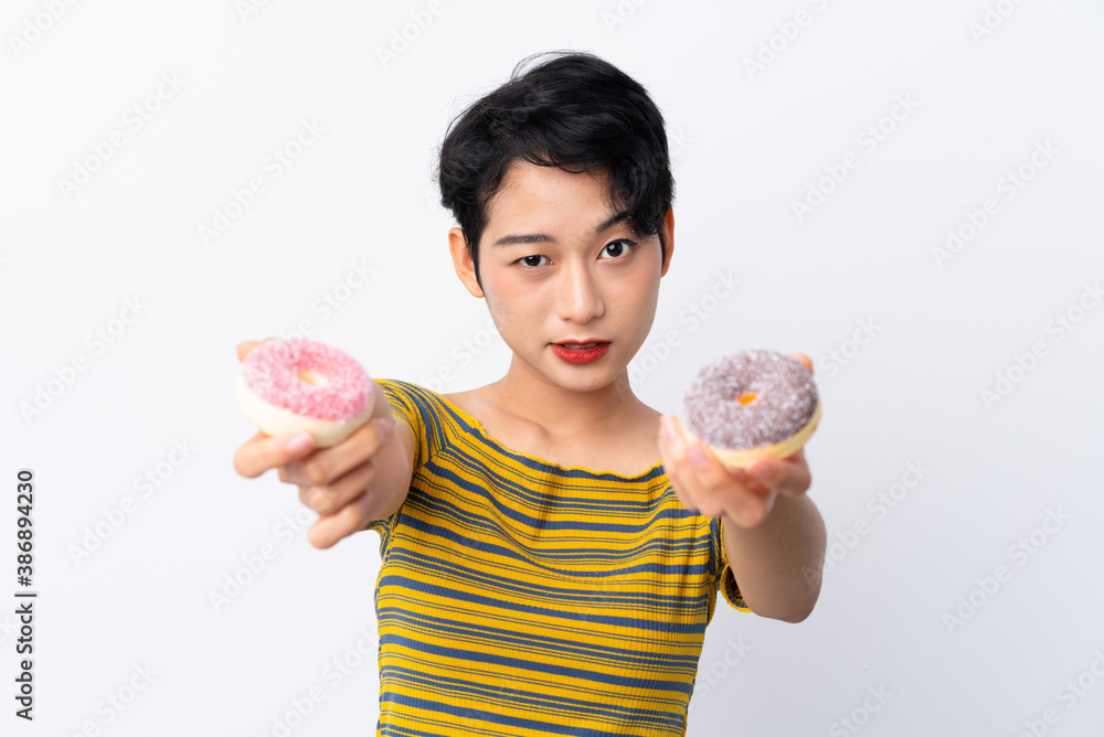Young Asian girl holding a donut and sad Young Asian girl holding a donut and sad