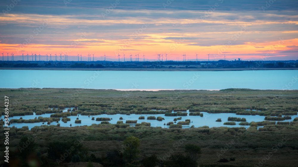 Fototapeta premium Sunrise with clouds on lake Neusiedlersee in Burgenland