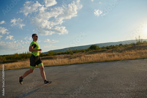 triathlon athlete running on morning trainig © .shock