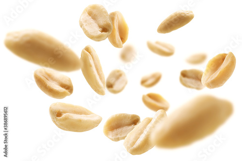 Peeled peanuts levitate on a white background photo