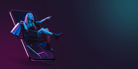 Beautiful woman inviting for shopping right from device screen, black friday, sales concept. Flyer. Cyber monday and online purchases, negative space for ad. Finance and money. Dark neon background.