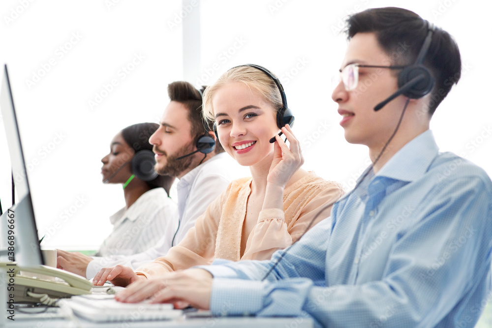Telemarketing concept. Happy hotline operators selling goods or services through VoIP telephony at call centre Telemarketing concept. Happy hotline operators selling goods or services through VoIP telephony at call centre